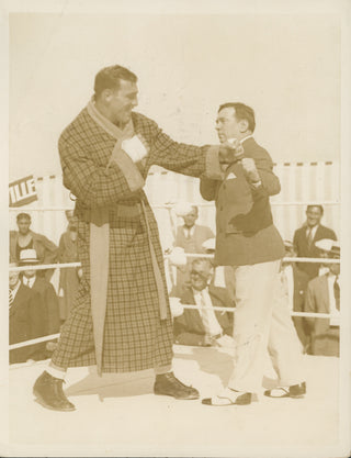 [Boxing] Carnera, Primo. (1906–1967) & Johnston, James J. (1875–1946) "A New One for the Repertoire" - Photograph of Carnera and Johnston in the ring.