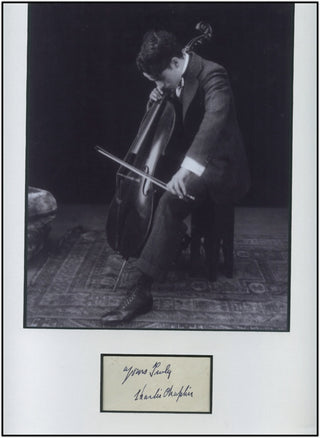 Chaplin, Charlie. (1889-1977) Autograph Signature matted with photograph of Chaplin playing Cello!