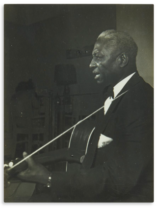 ["Lead Belly"] Ledbetter, Huddie William. (1888 - 1949) [Lomax, John A. and Alan; editors. ] Negro Folk Songs as Sung by Lead Belly - INSCRIBED PRESENTATION COPY TO PHOTOGRAPHER BEN ZELLER