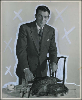 [Hollywood] Peck, Gregory. (1916–2003) Vintage Photograph Cutting a Turkey