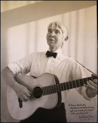 Sandburg, Carl. (1878 - 1967) Signed Photograph Playing Guitar