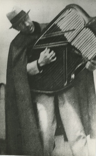 [Stravinsky, Igor. (1882–1971)] Original Photograph of the composer "playing" the grill of a Citroen, in the style of Apollo!