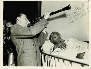 [Jazz & Song] [Handy, W.C. (1873-1958)] Herman, Woody. (1913 - 1987) Signed Photograph of Herman playing to a sick W. C. Handy